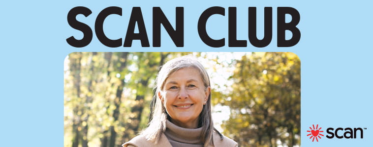 Senior woman on an autumn day smiles near trees.