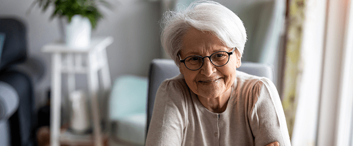 Senior woman smiles at camera.